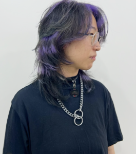 Staggered purple and black horizontal hair bands creating a shimmering movement effect on layered hair.