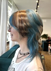 High-contrast blonde and dark brown raccoon tail stripes on a graphic face framing.